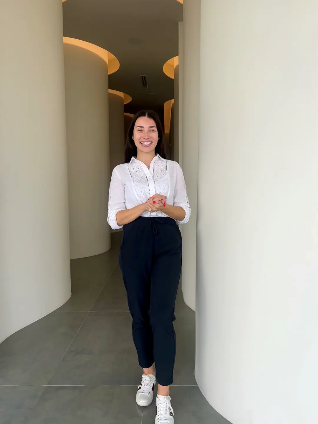A LeBlanc team member smiling in the office's curved hallway